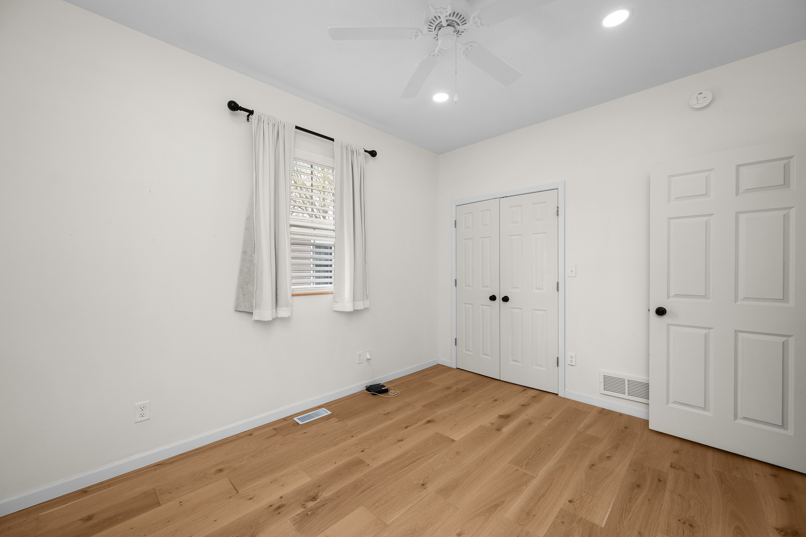 317 South Walnut Street Wilton, IA 52778 - Photo 25 of 45 a view of empty room with wooden floor and fan