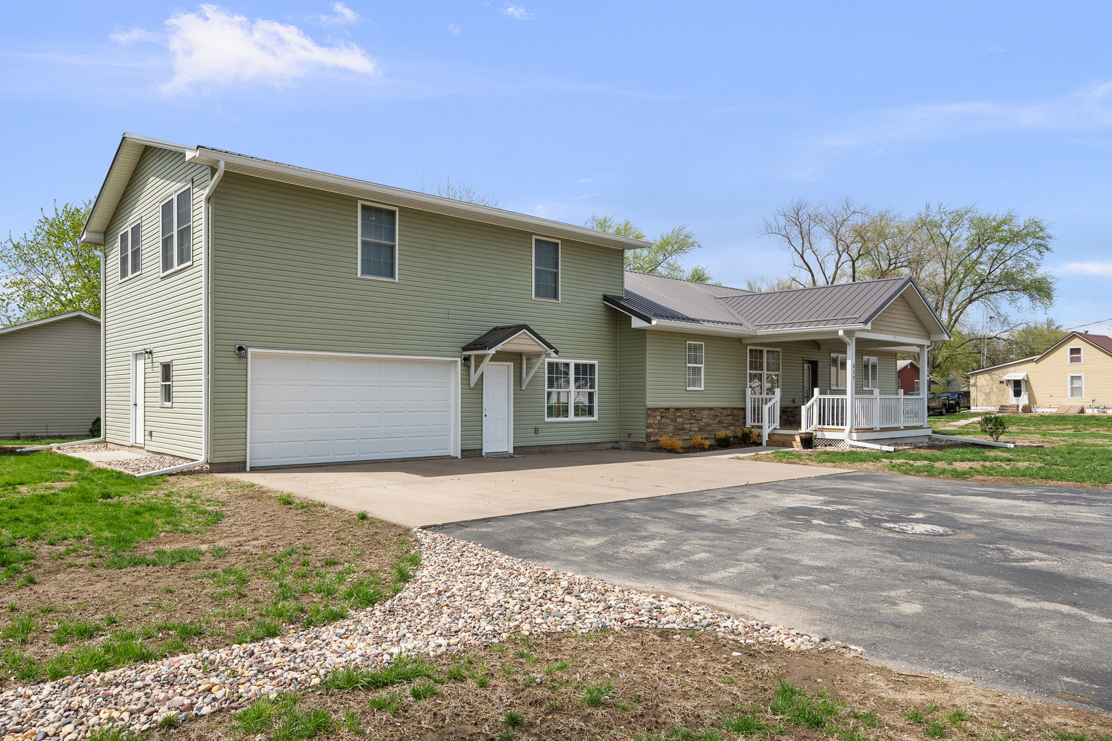 317 South Walnut Street Wilton, IA 52778 - Photo 3 of 45 a front view of a house with a yard and garage