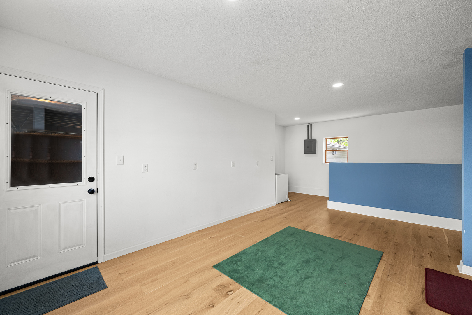 317 South Walnut Street Wilton, IA 52778 - Photo 35 of 45 an empty room with wooden floor and mirror