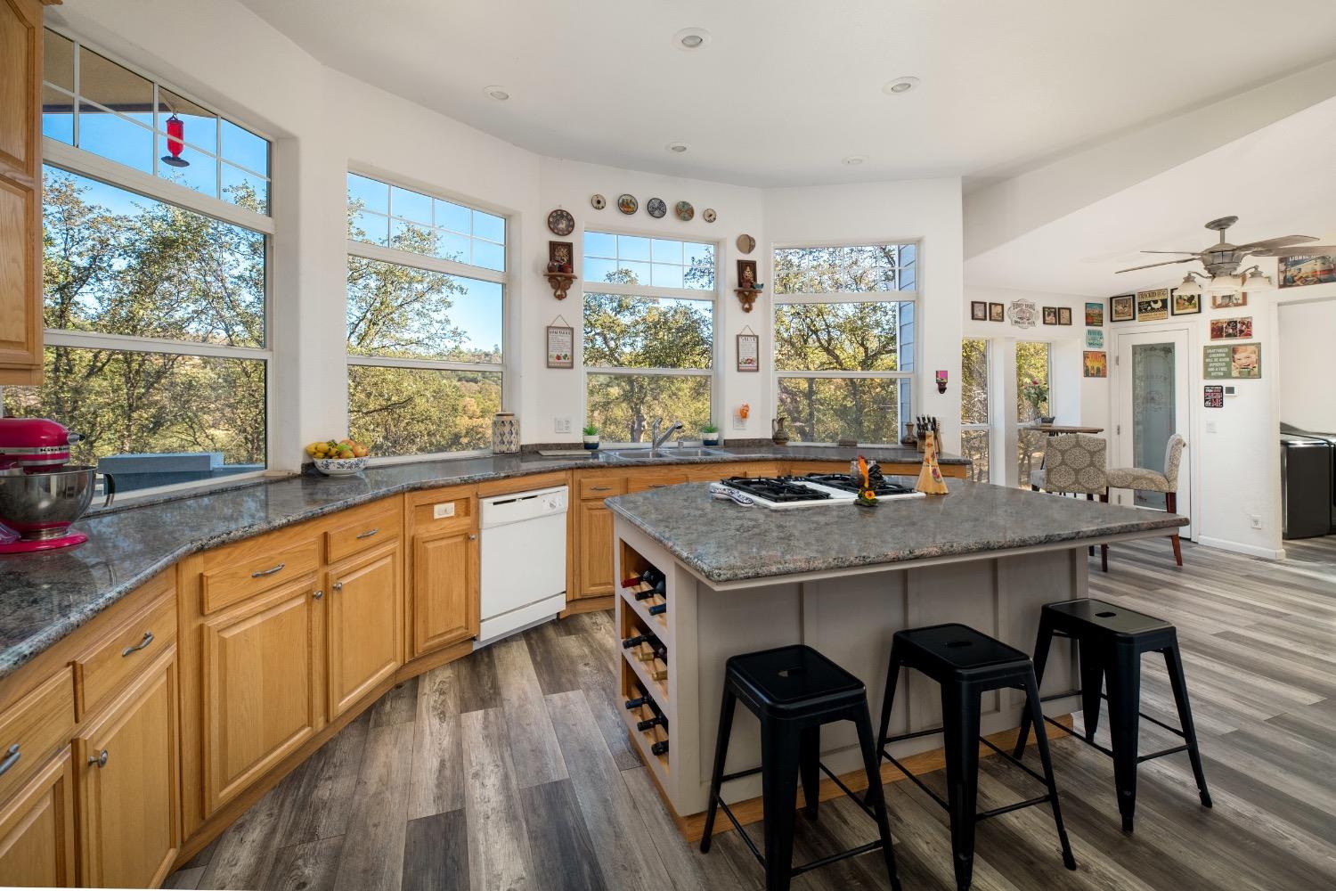 24090 Restive Way Grass Valley, CA 95949 - Photo 20 of 75 a kitchen with stainless steel appliances granite countertop a stove a refrigerator a sink and wooden cabinets