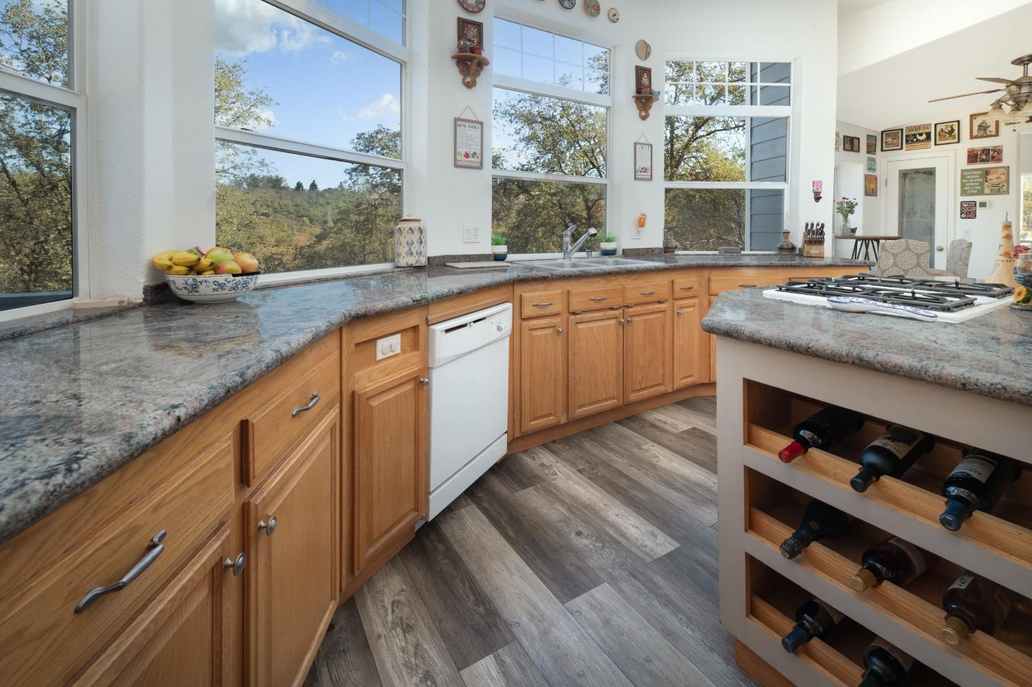 24090 Restive Way Grass Valley, CA 95949 - Photo 24 of 75 a kitchen with stainless steel appliances granite countertop a sink stove and cabinets