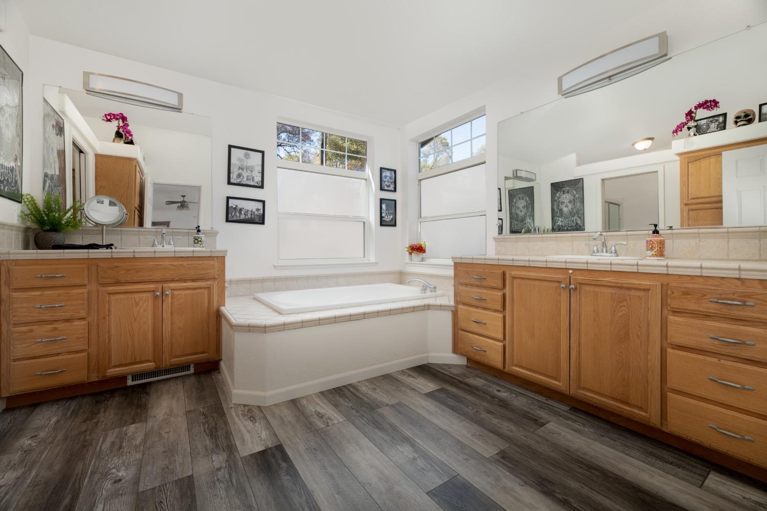 24090 Restive Way Grass Valley, CA 95949 - Photo 34 of 75 a spacious bathroom with a tub sink and mirror