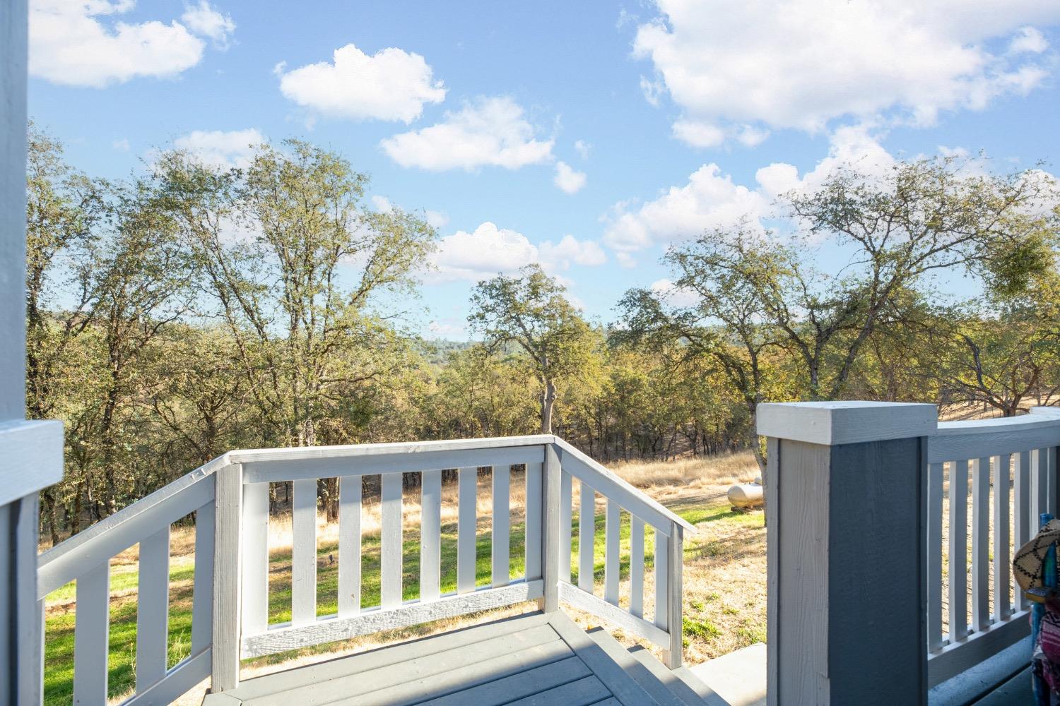 24090 Restive Way Grass Valley, CA 95949 - Photo 45 of 75 a view of a white house with a big yard and wooden fence