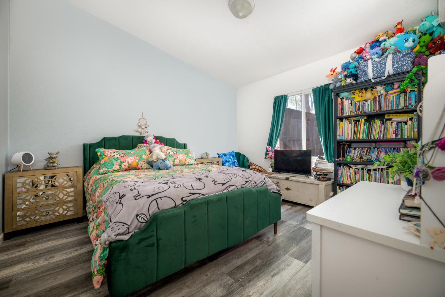 24090 Restive Way Grass Valley, CA 95949 - Photo 47 of 75 a bedroom with a bed and a bookshelf in it