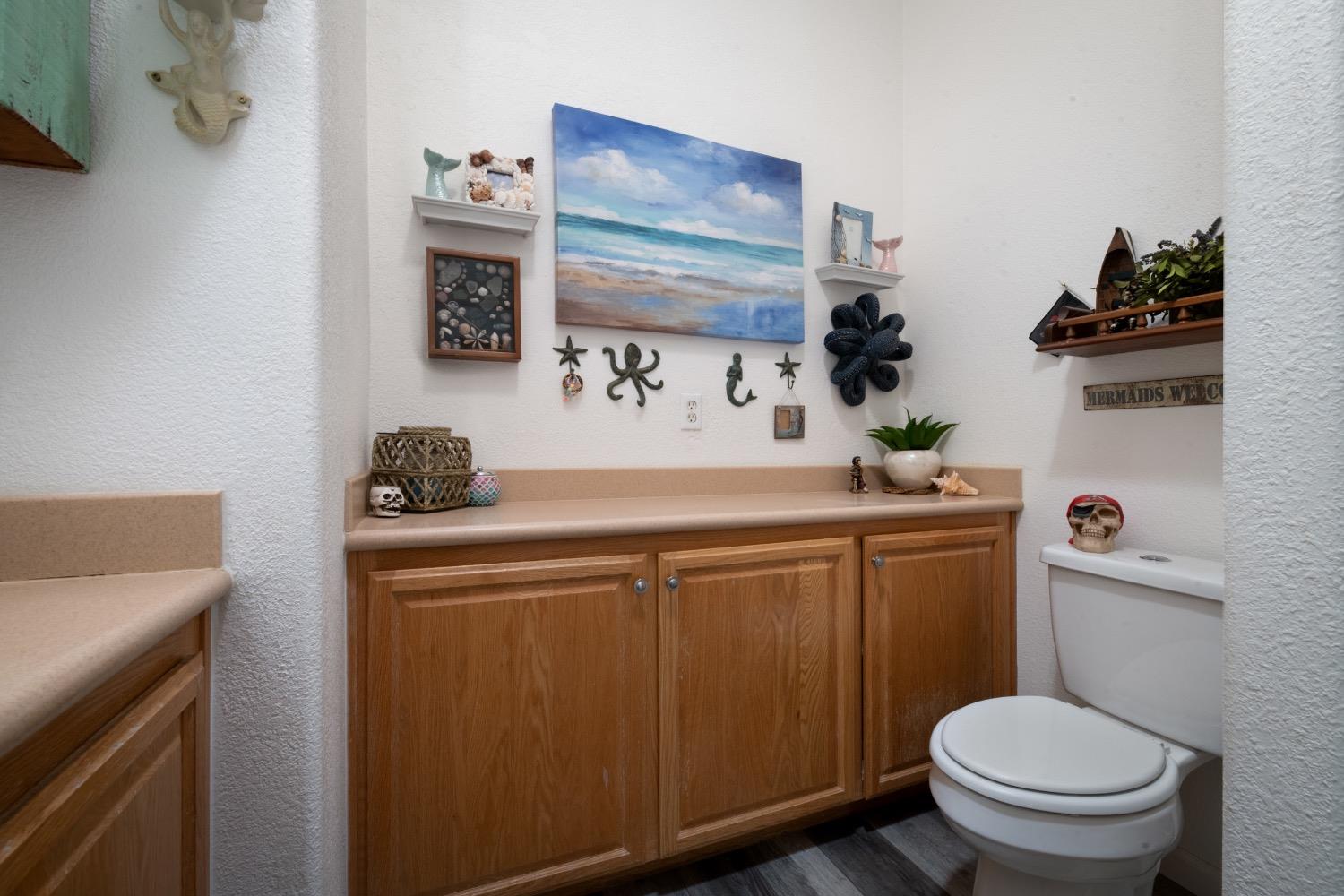 24090 Restive Way Grass Valley, CA 95949 - Photo 55 of 75 a bathroom with a toilet sink and mirror