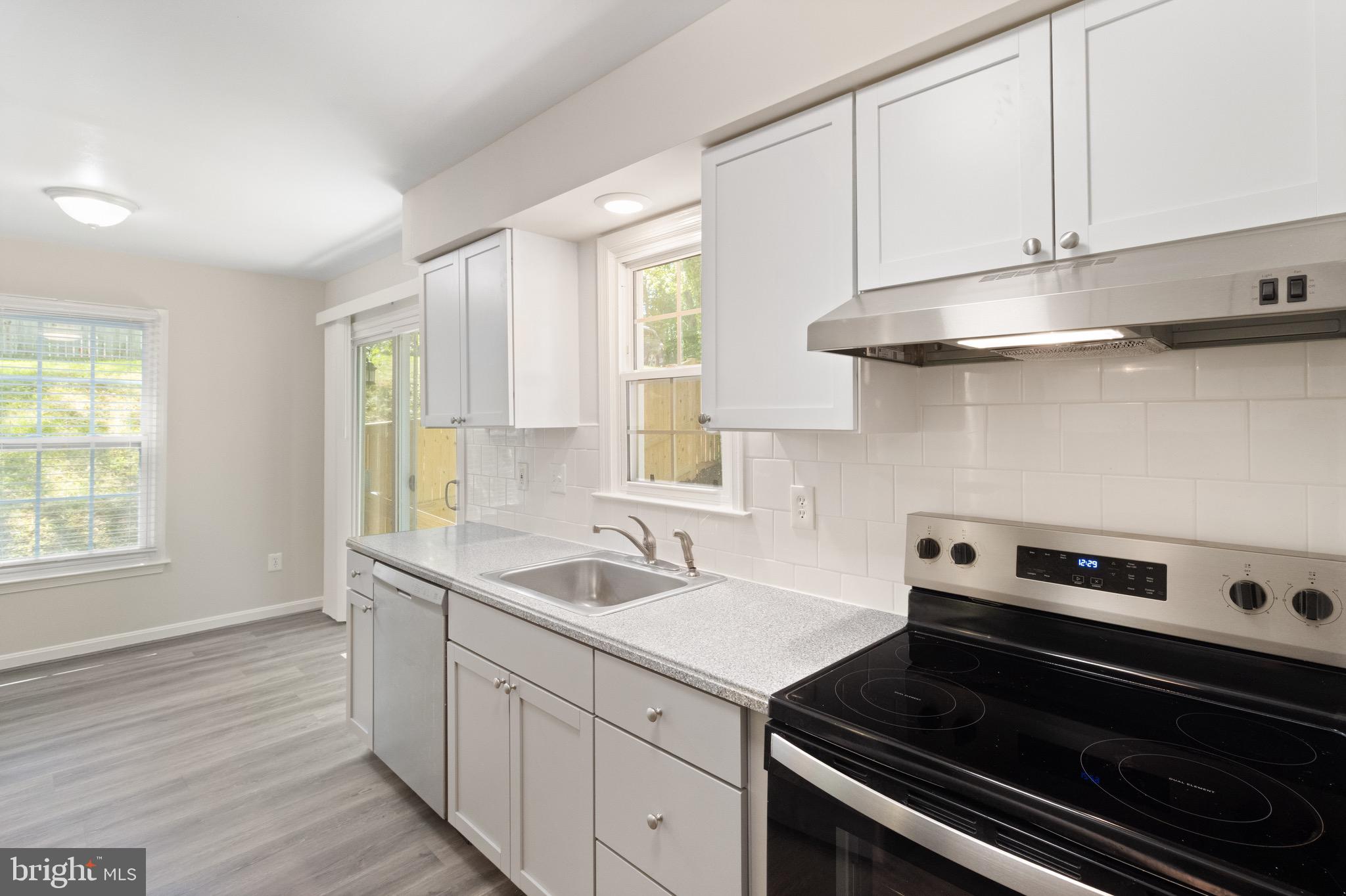 8581 Chester Grove Court Springfield, VA 22153 - Photo 11 of 38 a kitchen with a sink stove and cabinets