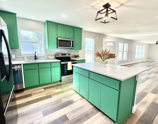 a kitchen with sink and cabinets