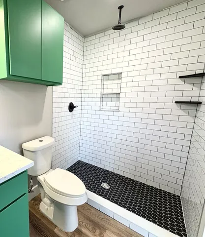 a bathroom with a toilet and a shower
