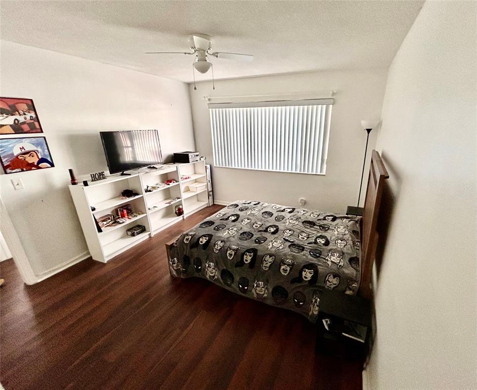 350 South Cypress Road, Unit 521 Pompano Beach, FL 33060 - Photo 12 of 18 a bedroom with a bed and a flat screen tv