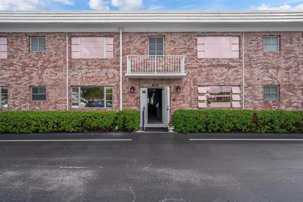 350 South Cypress Road, Unit 521 Pompano Beach, FL 33060 - Photo 18 of 18 a front view of a house with a garden and garage