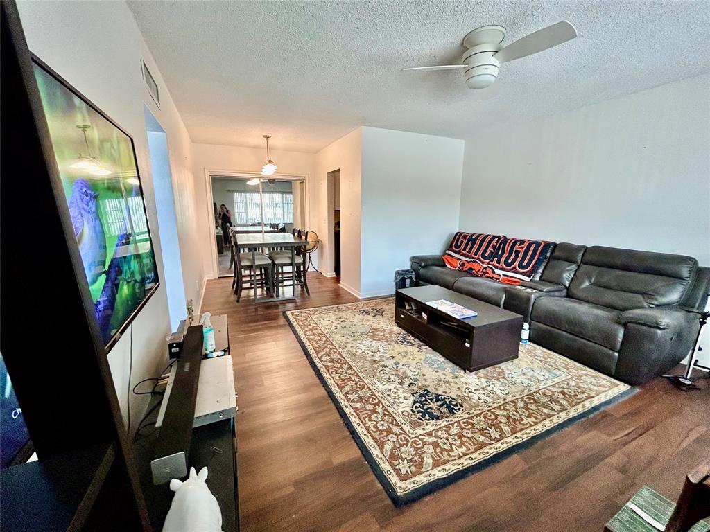 350 South Cypress Road, Unit 521 Pompano Beach, FL 33060 - Photo 3 of 18 a living room with furniture and a rug