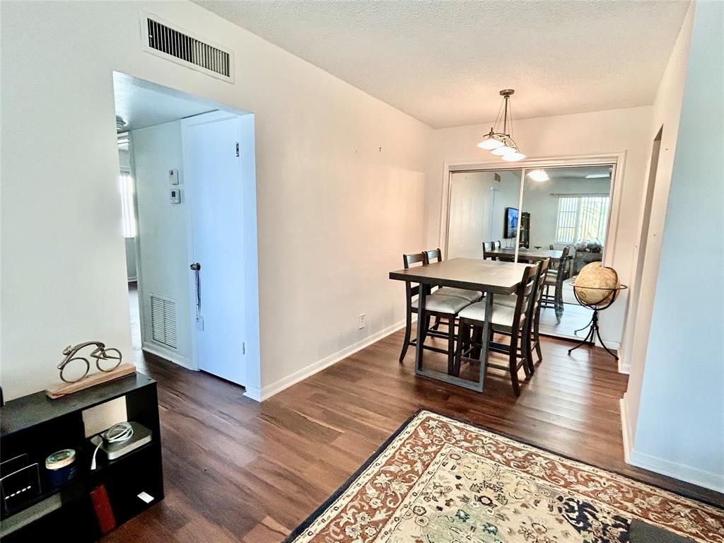350 South Cypress Road, Unit 521 Pompano Beach, FL 33060 - Photo 5 of 18 a view of a dining room with furniture and wooden floor