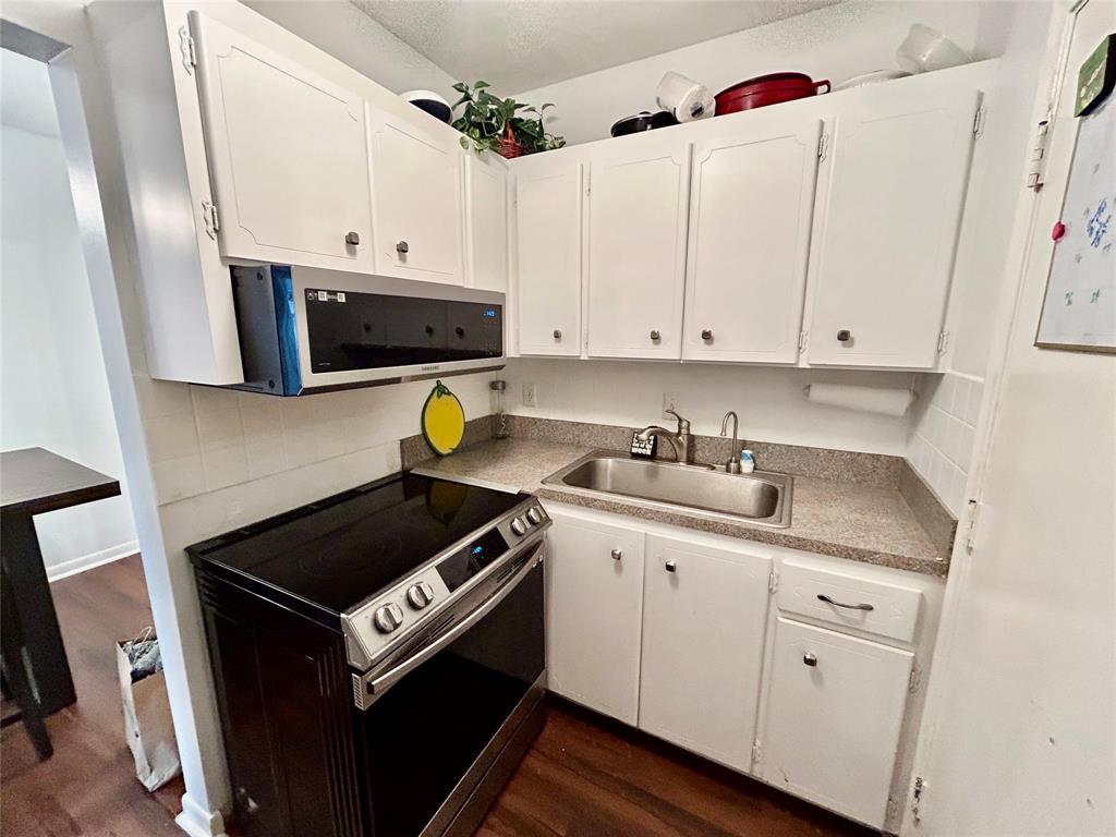 350 South Cypress Road, Unit 521 Pompano Beach, FL 33060 - Photo 7 of 18 a kitchen with a sink stove and cabinets