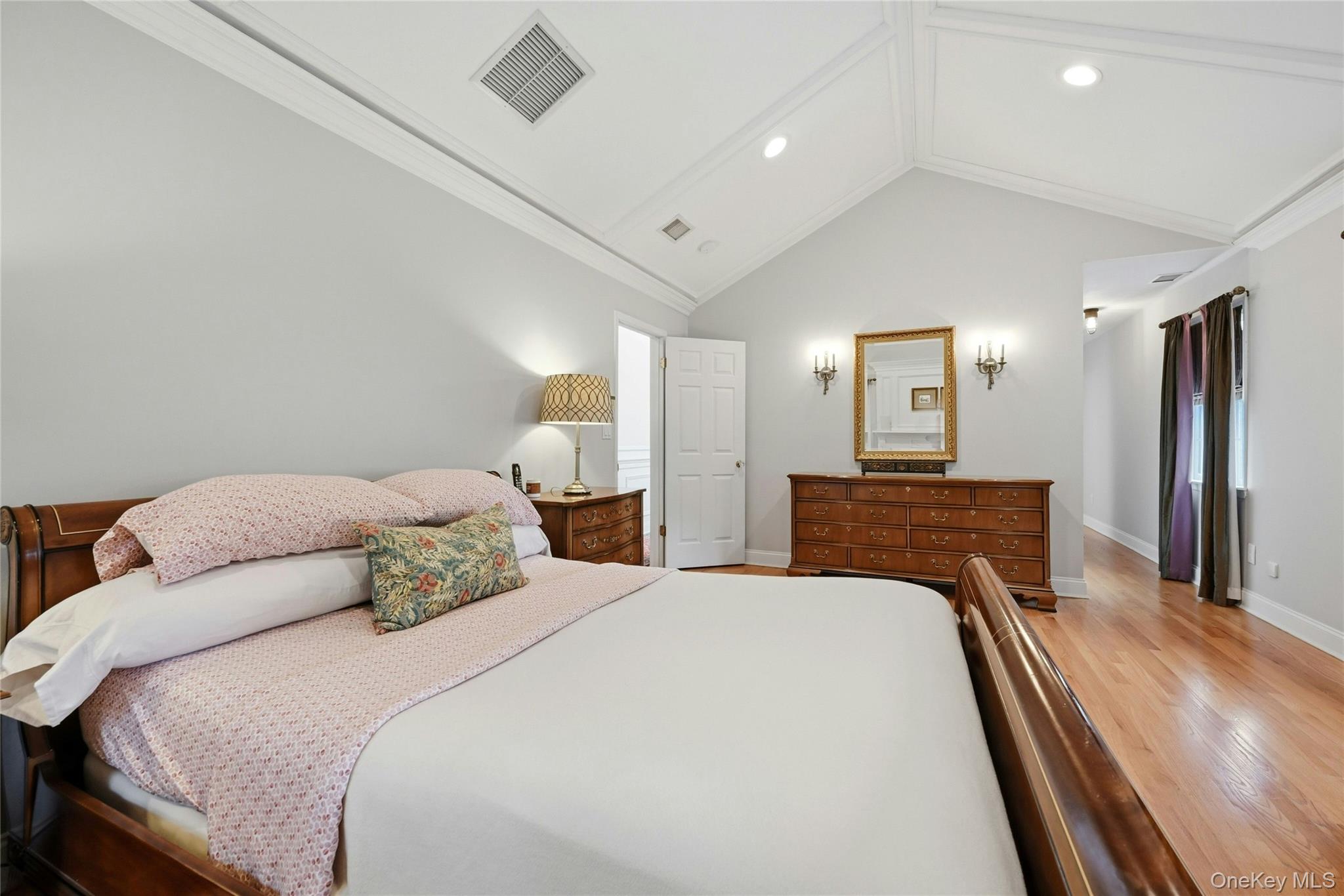 6 Thunder Road Miller Place, NY 11764 - Photo 25 of 50 Another View Of The Exquisite Primary Bedroom Suite Which Is An Elegant, Private Oasis Offering Soaring Custom Paneled Ceilings, Fireplace With A Stunning Custom Mantel, Marble Surround & Base, Box Paneled Trim & Beautiful Moldings/Details Flanked By Two Large Windows (There Are Five Large Windows In The Bedroom Illuminating The Room With Natural Light), Hardwood Floors, Ample Room For A Very Large Bedroom Set/Furniture, An Expansive Custom Built Walk In Closet With Built In Shelving/Storage, Second Double Sized Closet, And A Magnificent Primary Bathroom.
