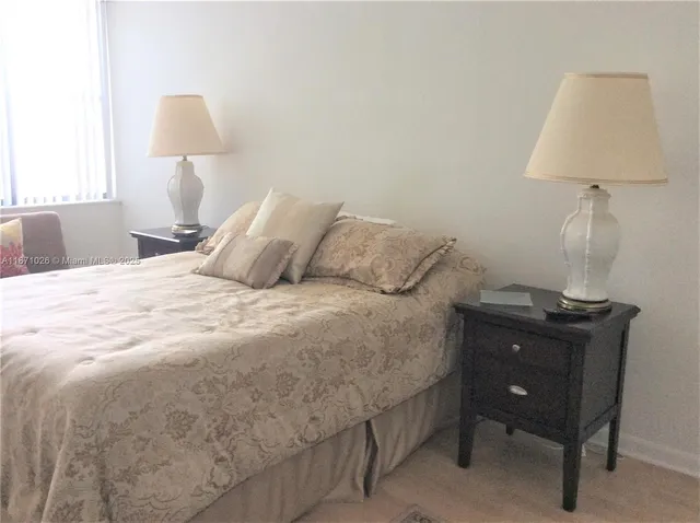 a bedroom with a bed and a lamp on table