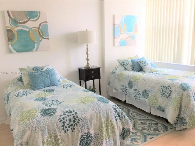 a bedroom with a bed and painting on the wall