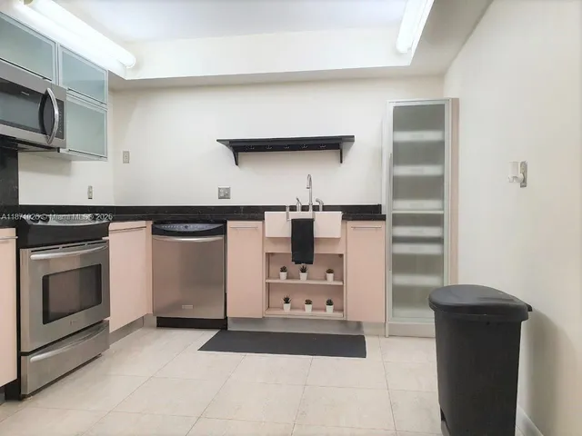 a kitchen with cabinets and appliances