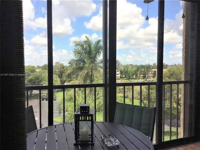 a view of a balcony with chairs