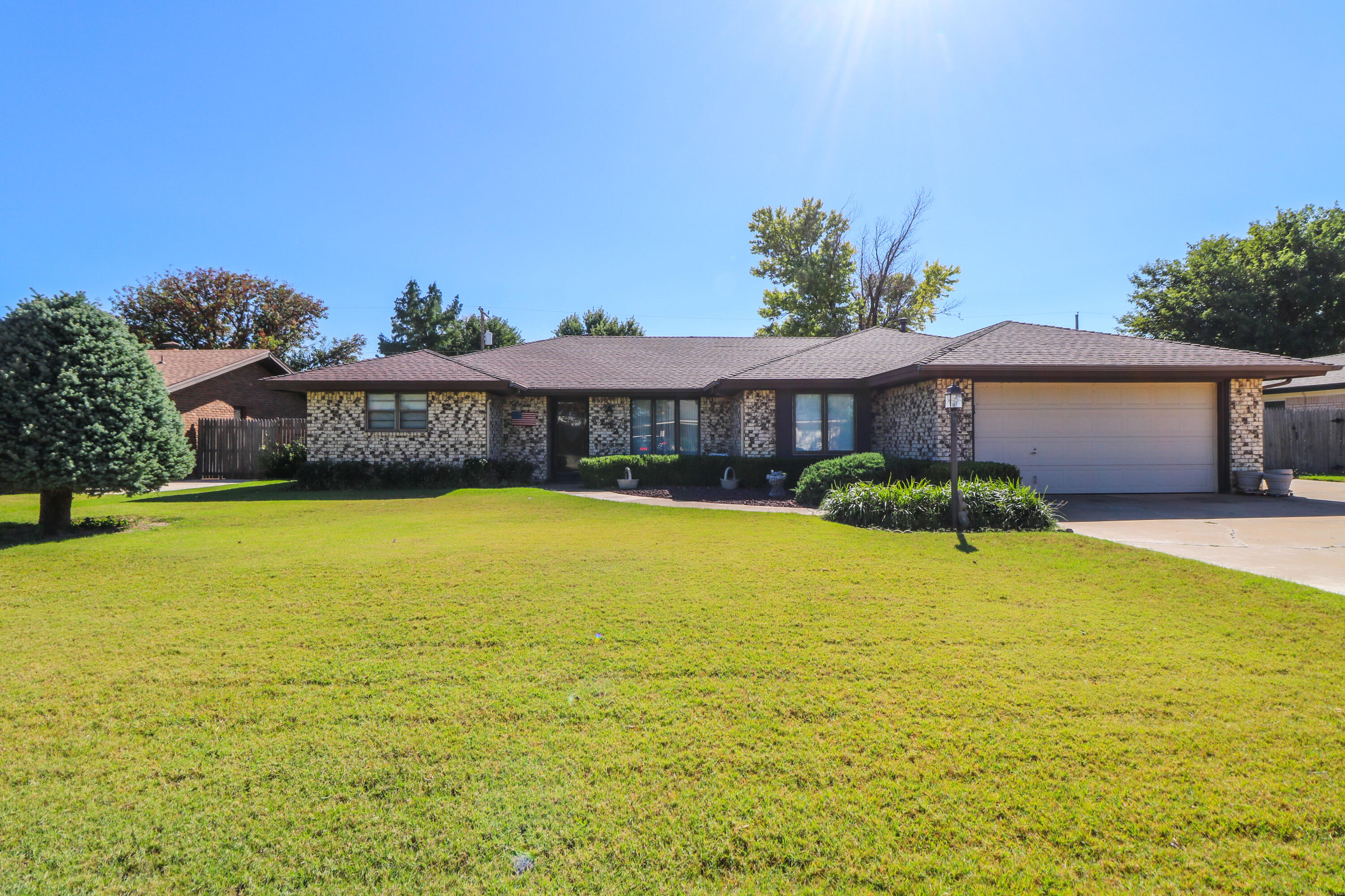 232 East 26th Street Littlefield, TX 79339 - Photo 1 of 26 a view of a swimming pool with lawn chairs under an umbrella