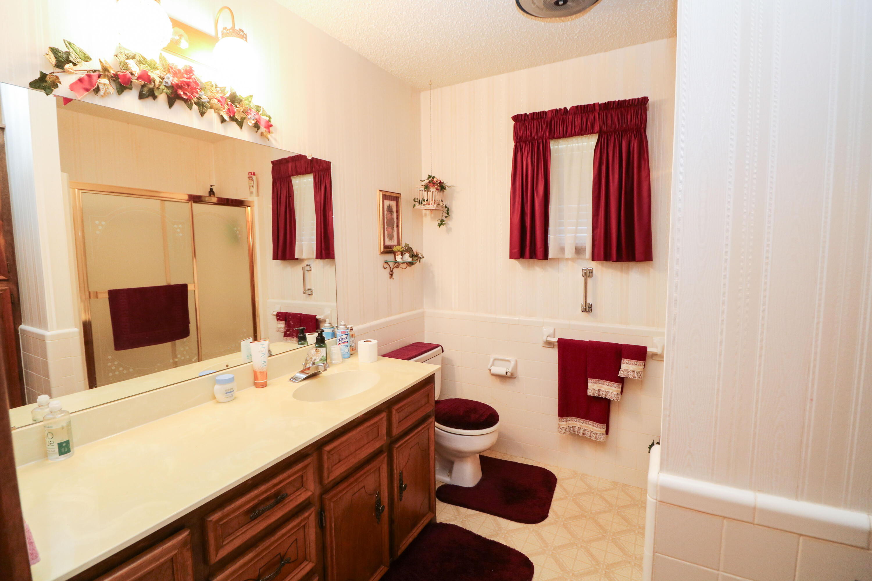 232 East 26th Street Littlefield, TX 79339 - Photo 18 of 26 a bathroom with a sink mirror and vanity