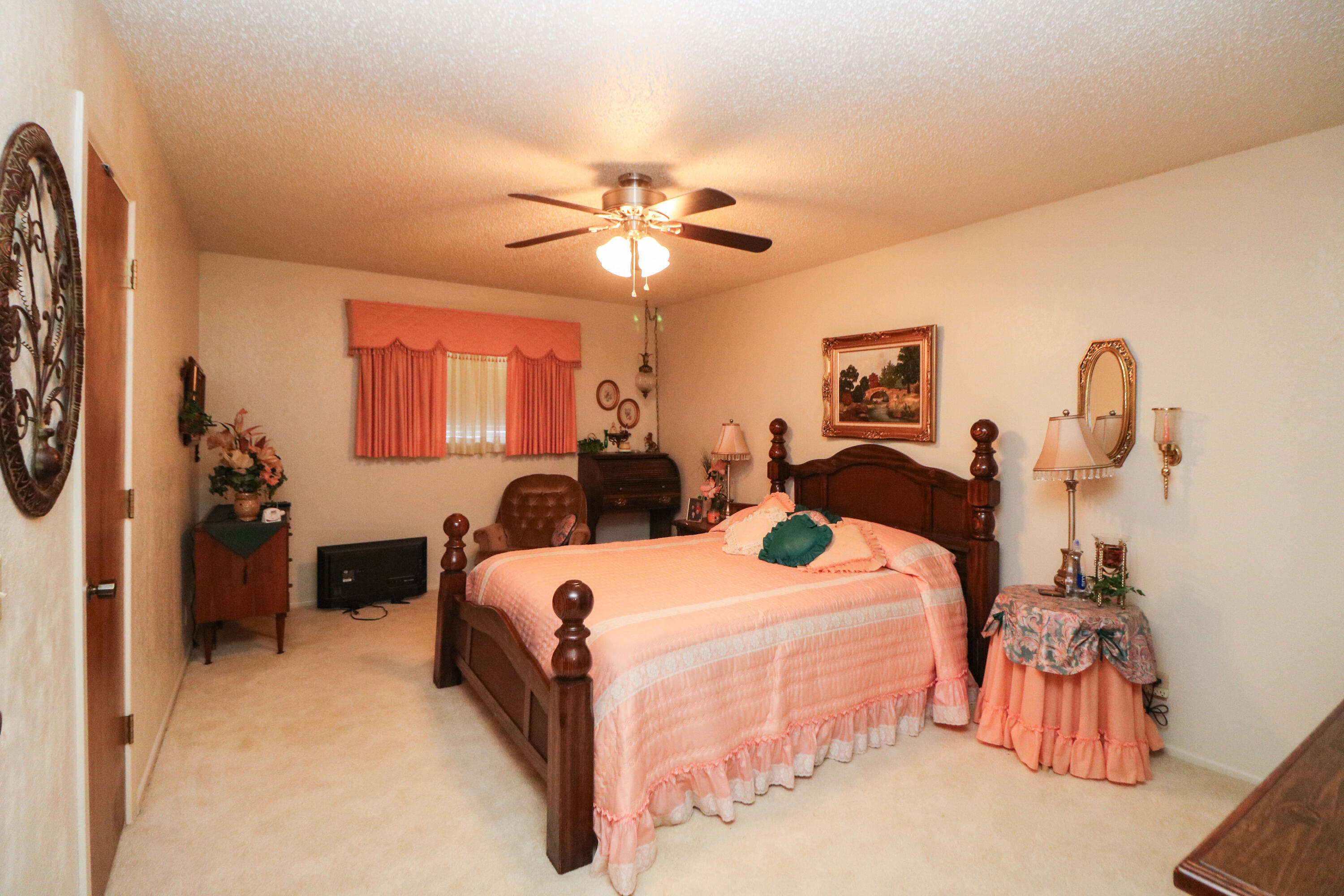 232 East 26th Street Littlefield, TX 79339 - Photo 19 of 26 a bedroom with double bed and a chandelier
