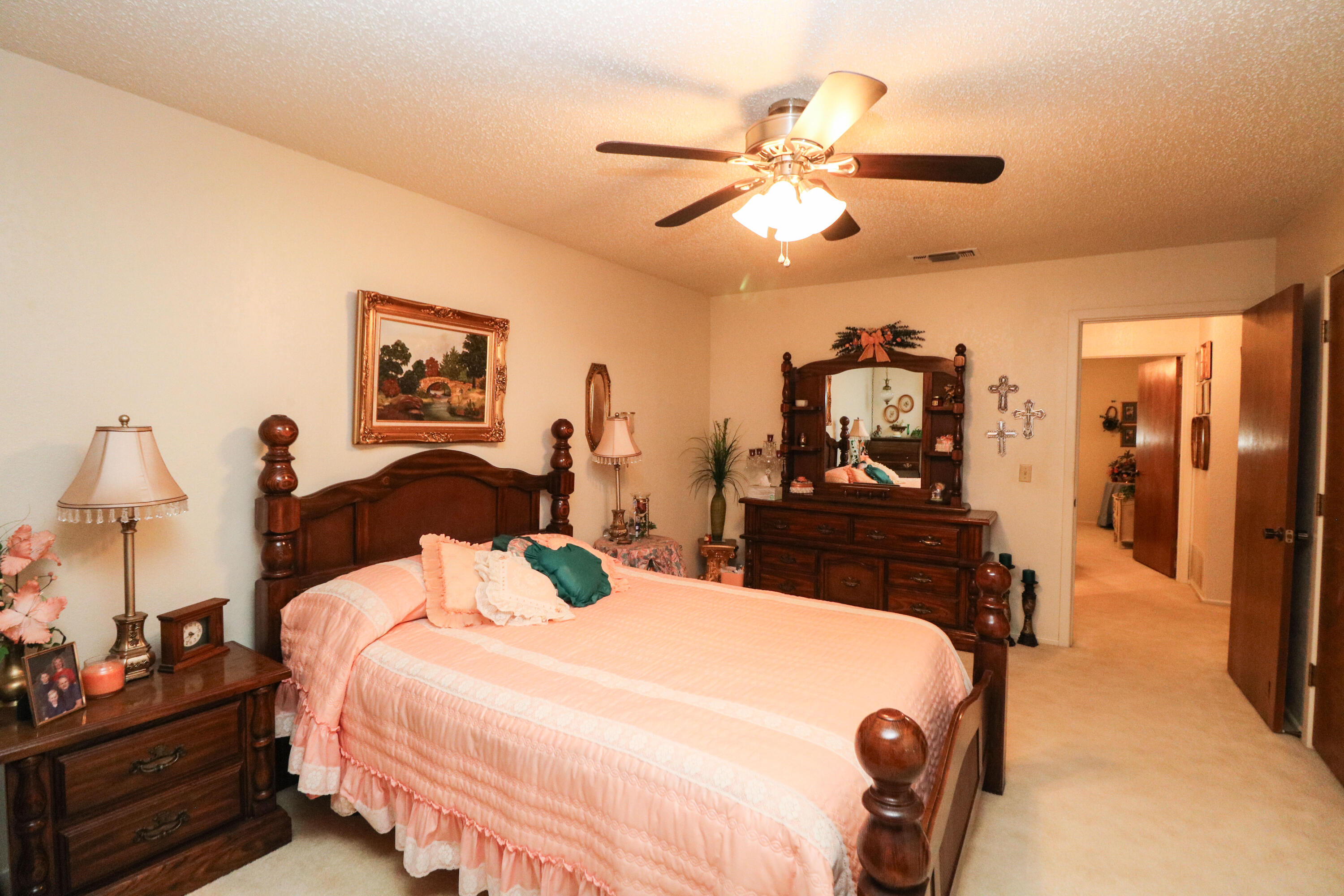 232 East 26th Street Littlefield, TX 79339 - Photo 20 of 26 a bedroom with a bed and a chandelier