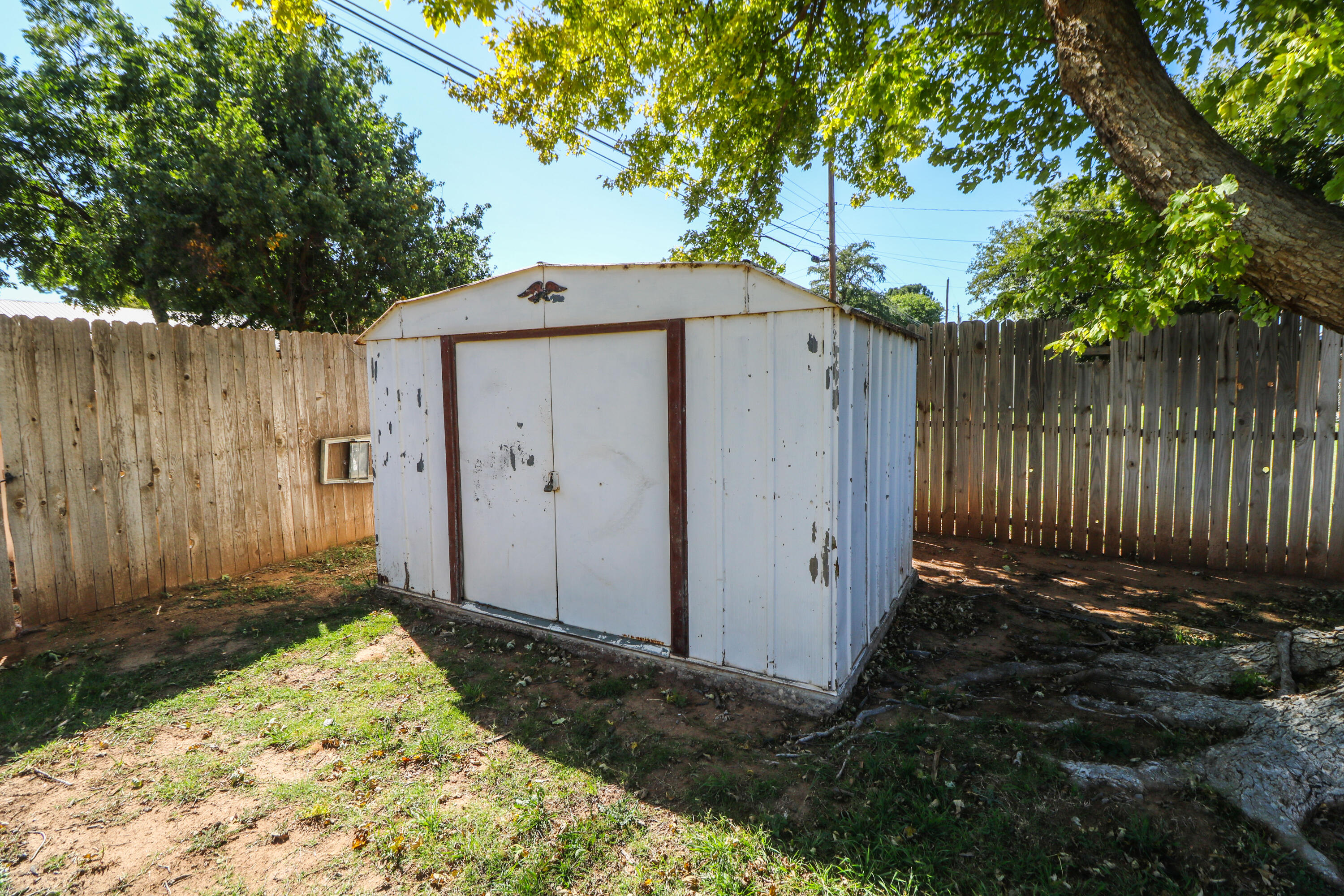 232 East 26th Street Littlefield, TX 79339 - Photo 23 of 26 a view of a house with a small yard and wooden fence