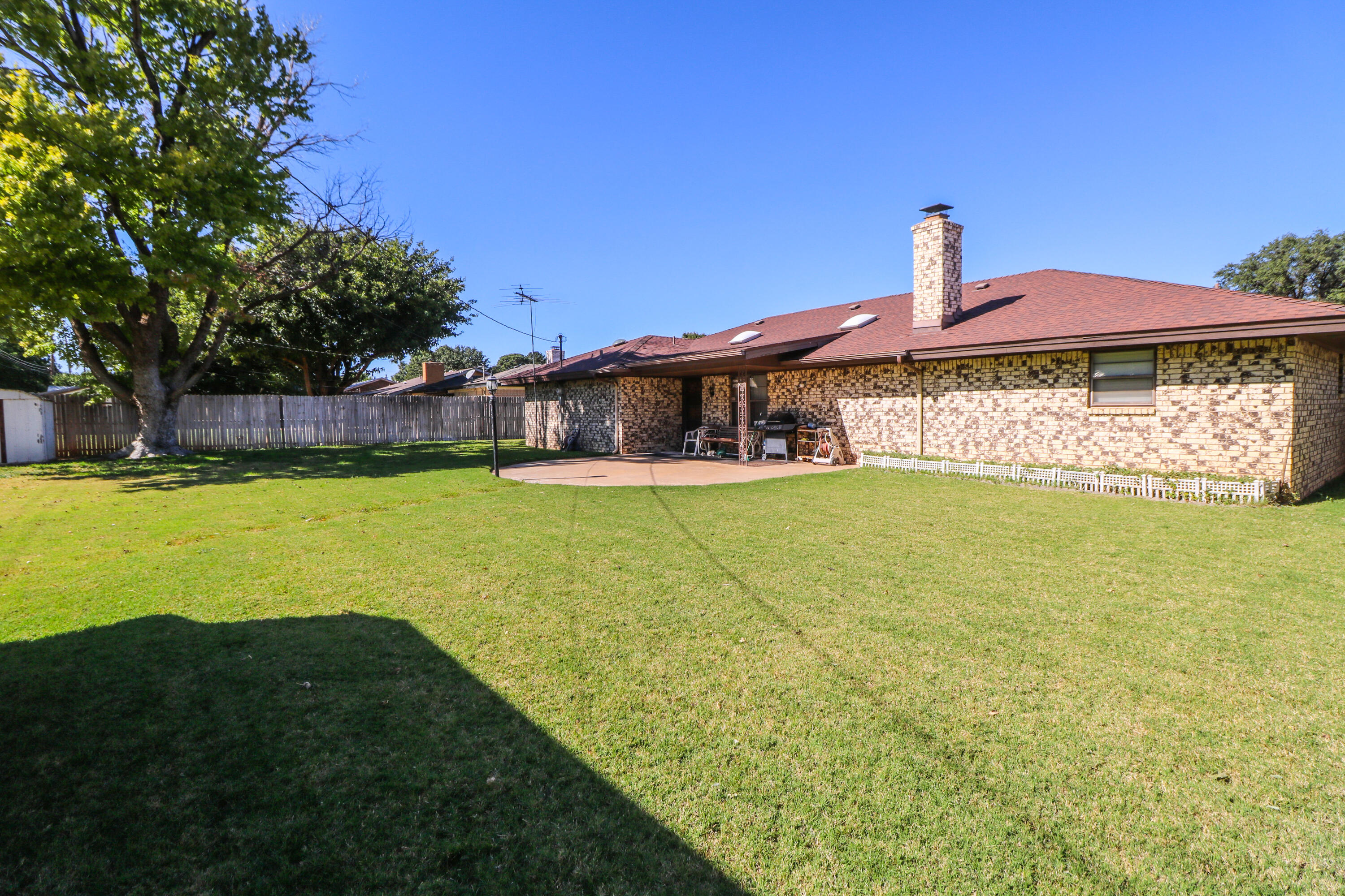 232 East 26th Street Littlefield, TX 79339 - Photo 25 of 26 a view of a house with a yard potted plants and large tree