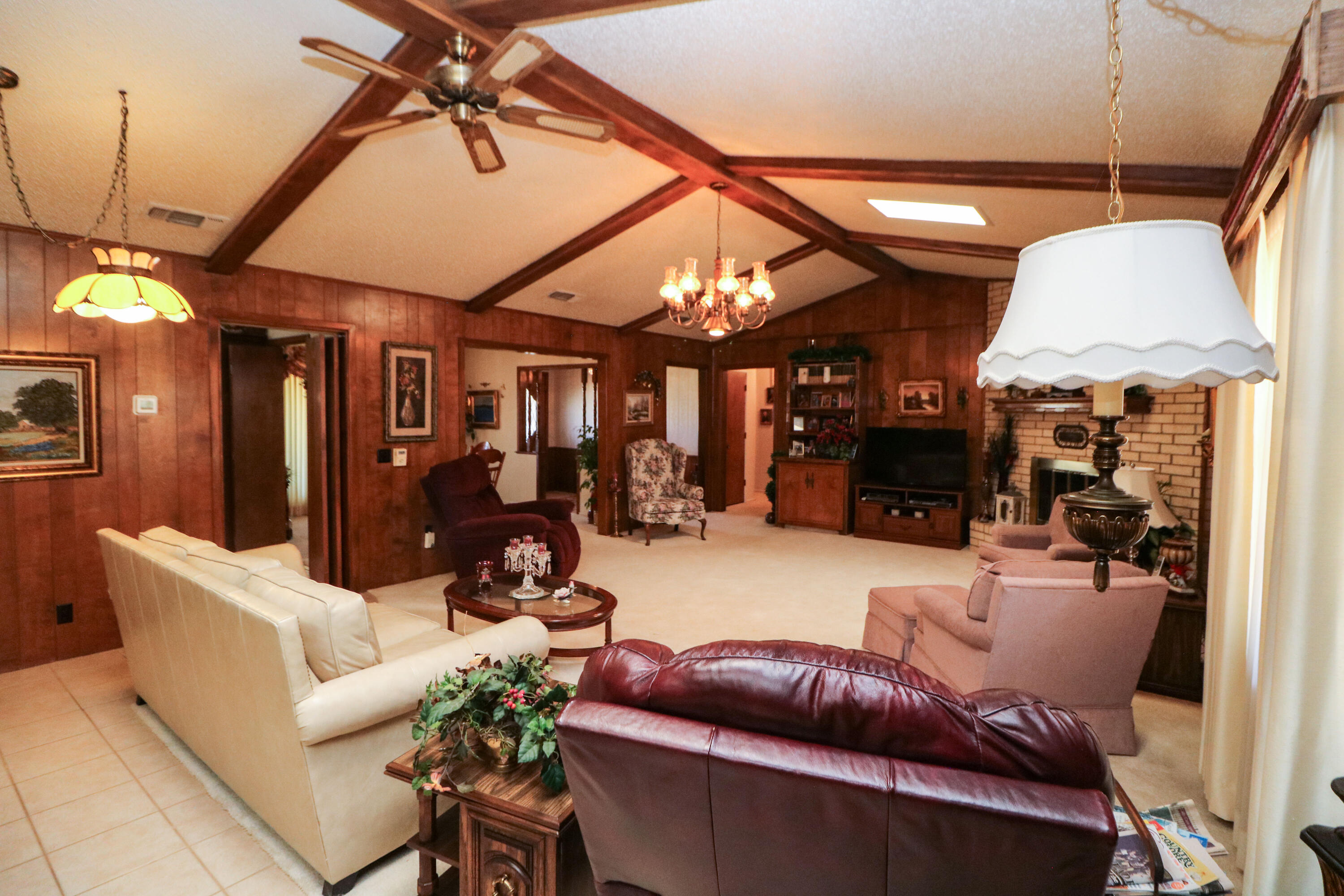 232 East 26th Street Littlefield, TX 79339 - Photo 5 of 26 a living room with furniture a fireplace and a chandelier