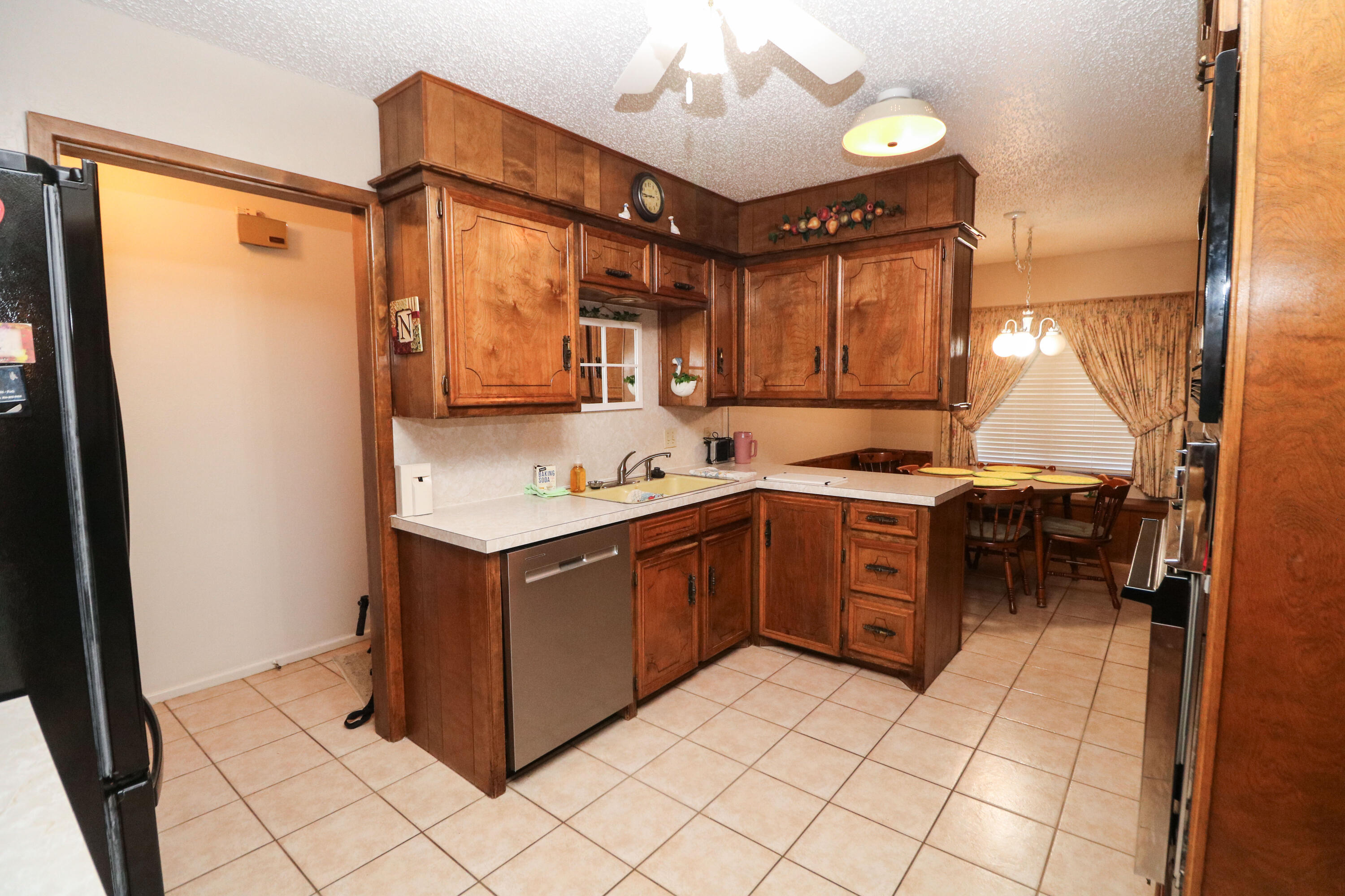 232 East 26th Street Littlefield, TX 79339 - Photo 8 of 26 a kitchen with a cabinets and a stove top oven