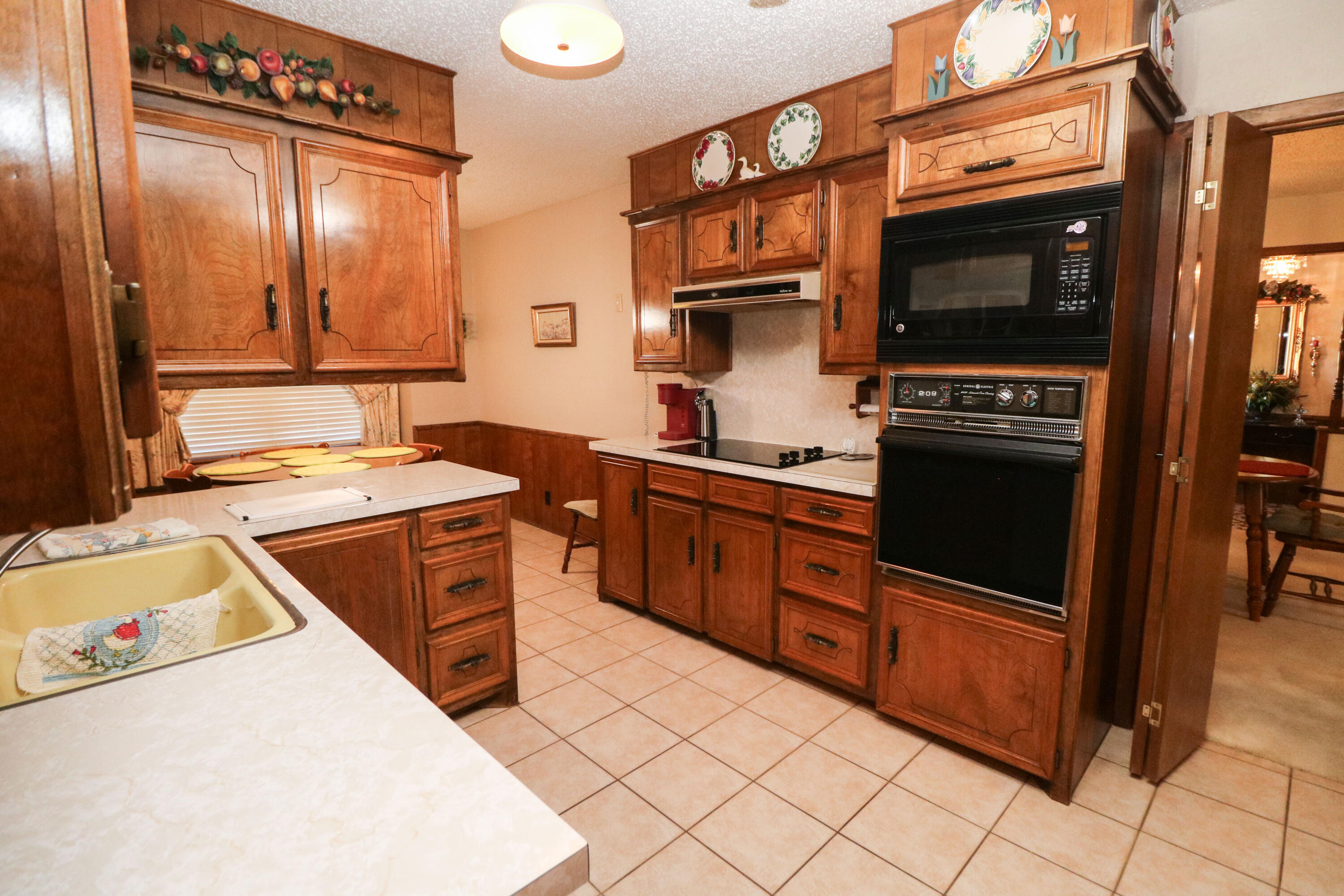 232 East 26th Street Littlefield, TX 79339 - Photo 9 of 26 a kitchen with stainless steel appliances granite countertop a stove and a microwave