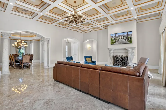 a spacious bedroom with a bed and a chandelier