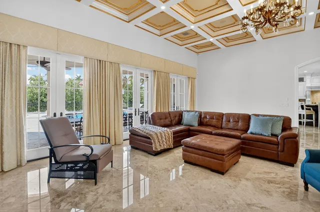 a bedroom with a large bed and a chandelier