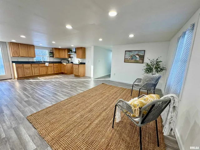 a living room with furniture and kitchen view