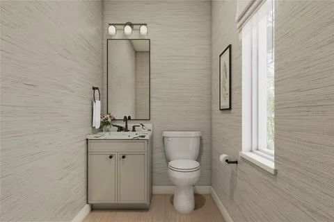 a bathroom with a toilet a sink and mirror