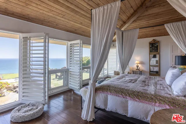 a bathroom with a tub a sink and a large mirror