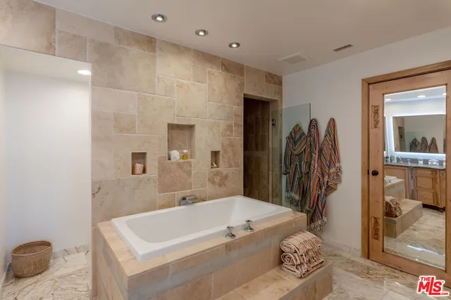 a bathroom with a sink double vanity and a mirror