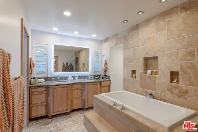 a bedroom with a bed and a night stand