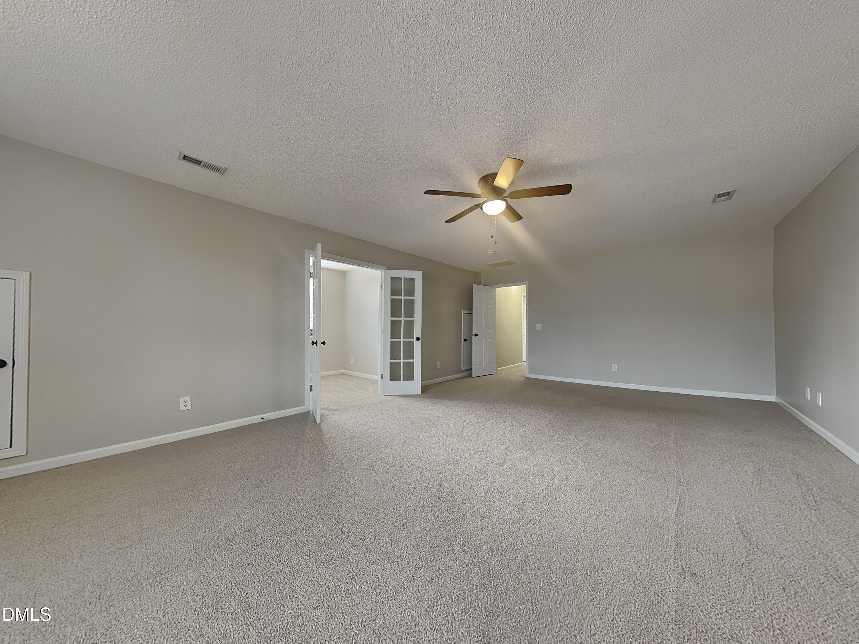 226 Linden Road Cameron, NC 28326 - Photo 18 of 20 a view of an empty room with a chandelier fan