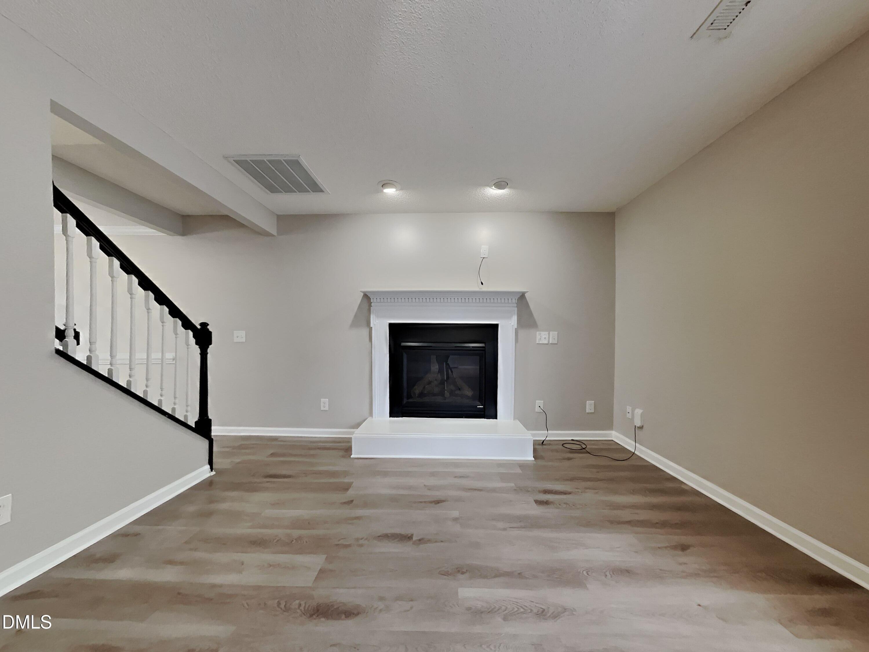 226 Linden Road Cameron, NC 28326 - Photo 3 of 20 a view of an empty room with wooden floor and a window