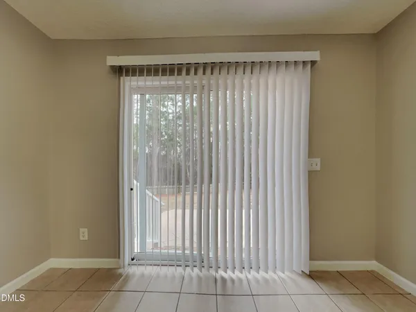 a view of a room that has a large window and door