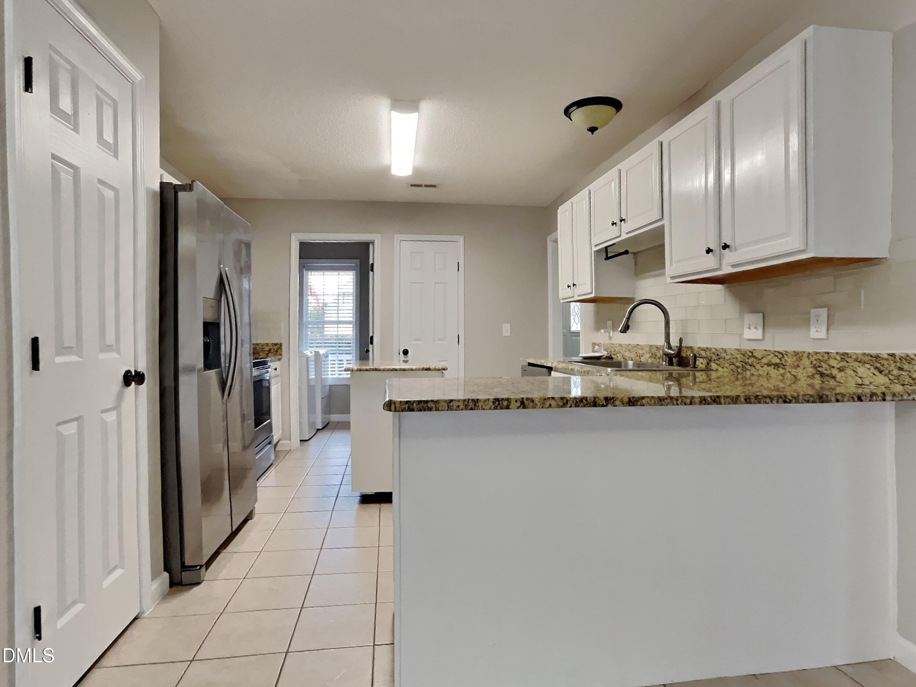 226 Linden Road Cameron, NC 28326 - Photo 6 of 20 a large white kitchen with granite countertop a sink