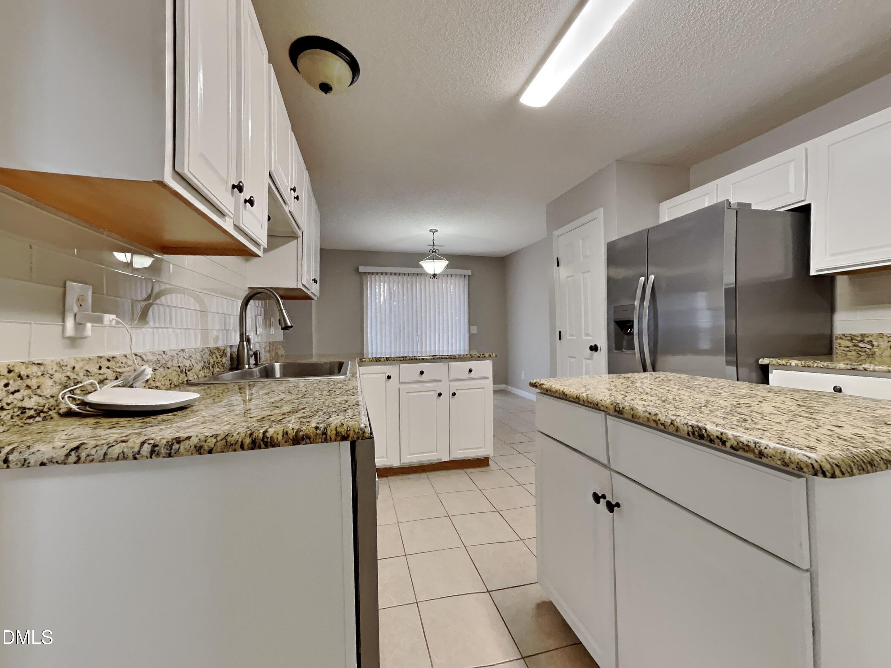 226 Linden Road Cameron, NC 28326 - Photo 7 of 20 a kitchen with stainless steel appliances granite countertop a sink stove and cabinets
