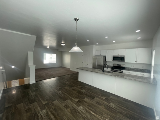 14760 Rising Star Way, Unit 71 Bluffdale, UT 84065 - Photo 12 of 41 Contemporary kitchen featuring white cabinetry, stainless steel appliances, granite countertops, and wood-finish flooring