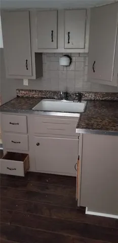 a kitchen with wooden cabinets and a stove top oven