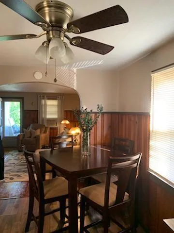 a view of a dining room with furniture and chandelier