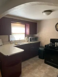 a kitchen with a sink appliances and a window