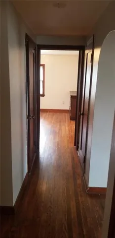 a view of a room with wooden floor and staircase