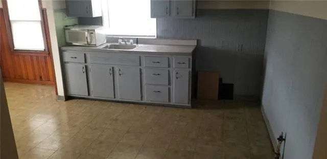 a kitchen with cabinets appliances and a window