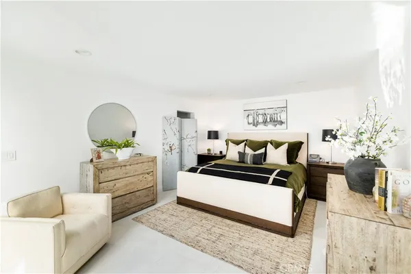 a large white kitchen with stainless steel appliances kitchen island granite countertop a refrigerator and a stove top oven
